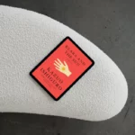 A tablet displaying the book cover of Klara and the Sun by Kazuo Ishiguro resting on a textured white surface