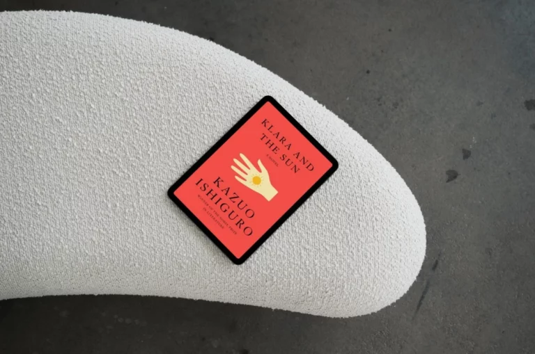 A tablet displaying the book cover of Klara and the Sun by Kazuo Ishiguro resting on a textured white surface